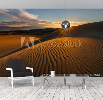 Bild på Picturesque desert landscape with a golden sunset over the dunes